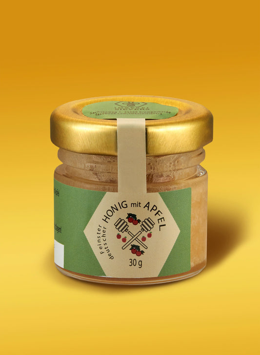 Premium Honig mit Apfel von ekovita, präsentiert in einem eleganten Glasgefäß, ideal für die Gesundheit.