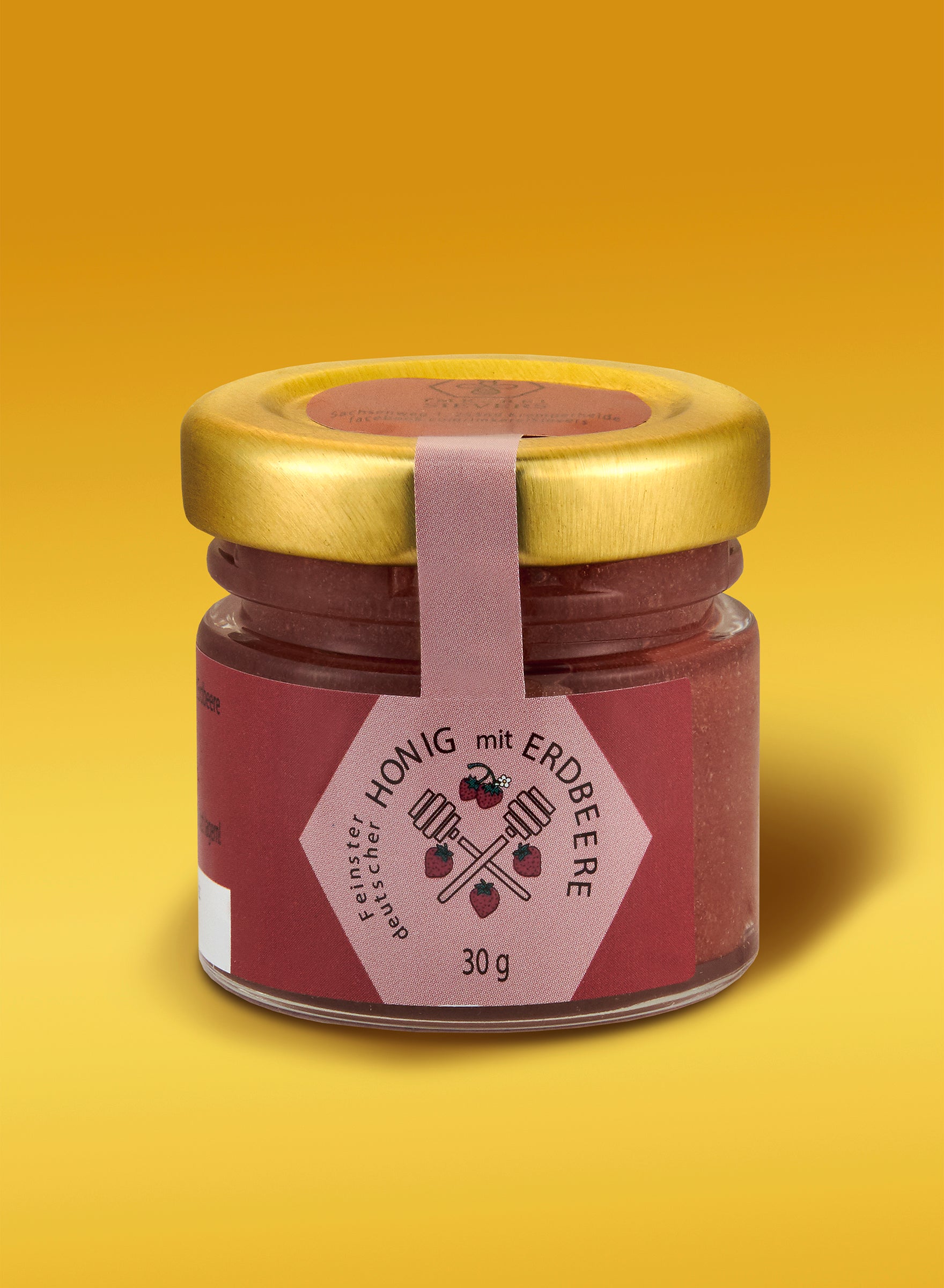 Ekovita Erdbeer-Honig in einem Glas mit frischen Erdbeeren, ideal für ein gesundes Frühstück.