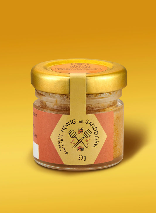 Premium Honig mit Sanddorn von ekovita in einem Glas mit goldener Farbe und reichhaltiger Textur.