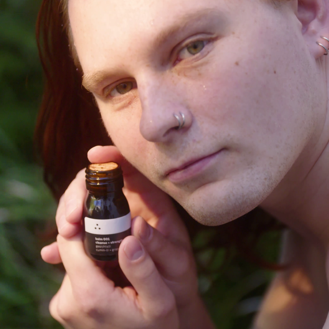 Balm 001 Gesichtsöl von therefore beauty in der offenen Flasche, auf einem Holzuntergrund.